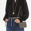 Cartera con solapa y cadena Chloé Iconic en piel brillante